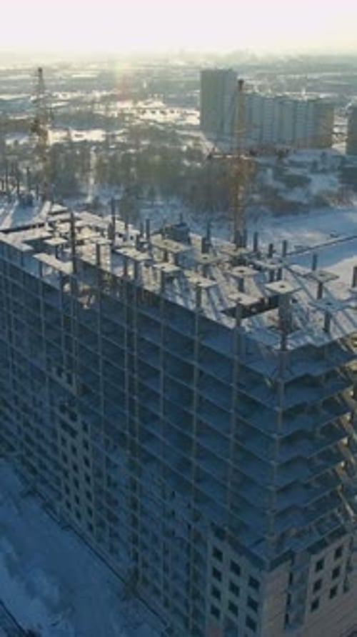 New Building Construction Progresses Under Winter Sun in Urban Area