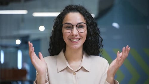 Webcam view. Smiling businesswoman talking on a video call looking at camera sitting in office.