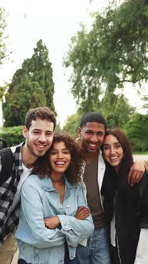 Diverse group of students happily posing in a park, showcasing friendship and diversity