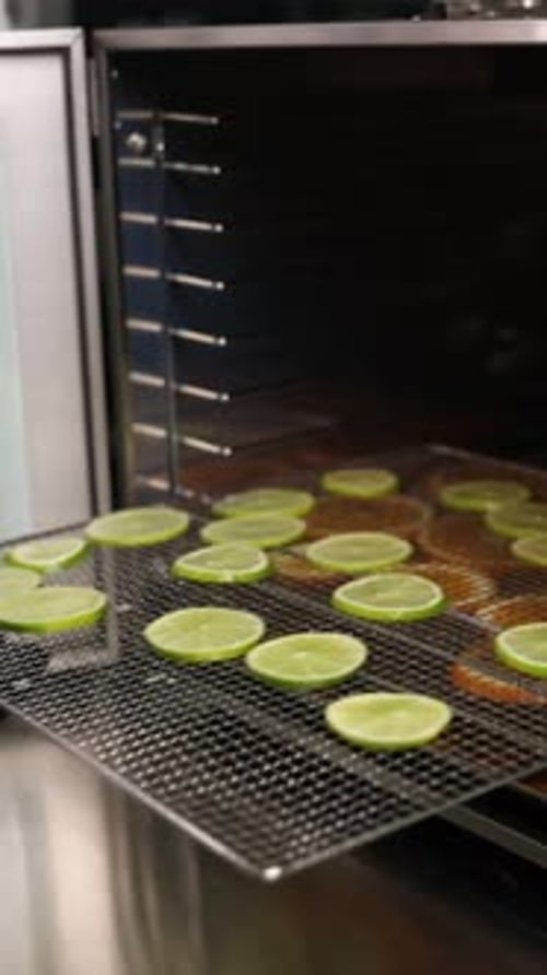 Chef prepares citrus fruits for dehydration
