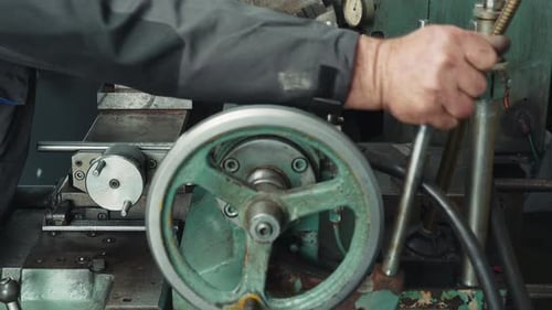 Machinist Operating Metal Lathe at Factory