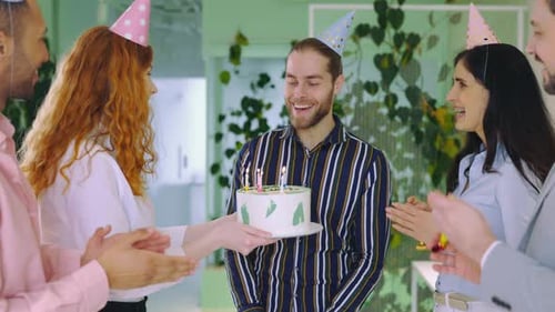 Happy Excited Guy Celebrating Birthday in the Office Happy Birthday Man Blowing Candles on the Cake