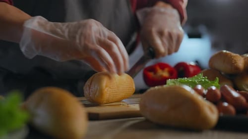 Yellow. Master pastry chef uses skills and experience to professionally cut bread loaf for hot dog