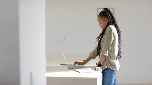 Woman Working at Laptop in Bright Home