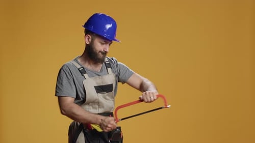 Handyman Mechanic Using Saw with Razor Used for Chopping Wood