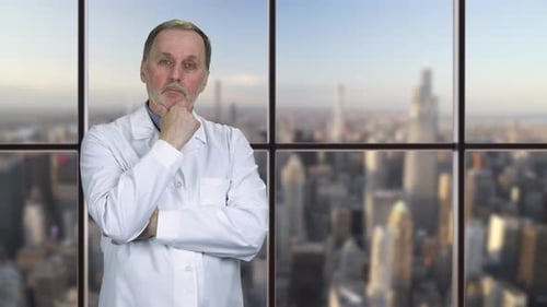 Doctor Thinks in Office with City View