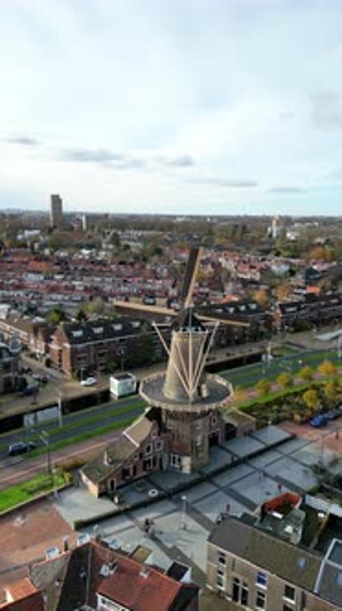 Aerial drone view of the Molen De Roos, historic windmill in Delft, Netherlands. Vertical
