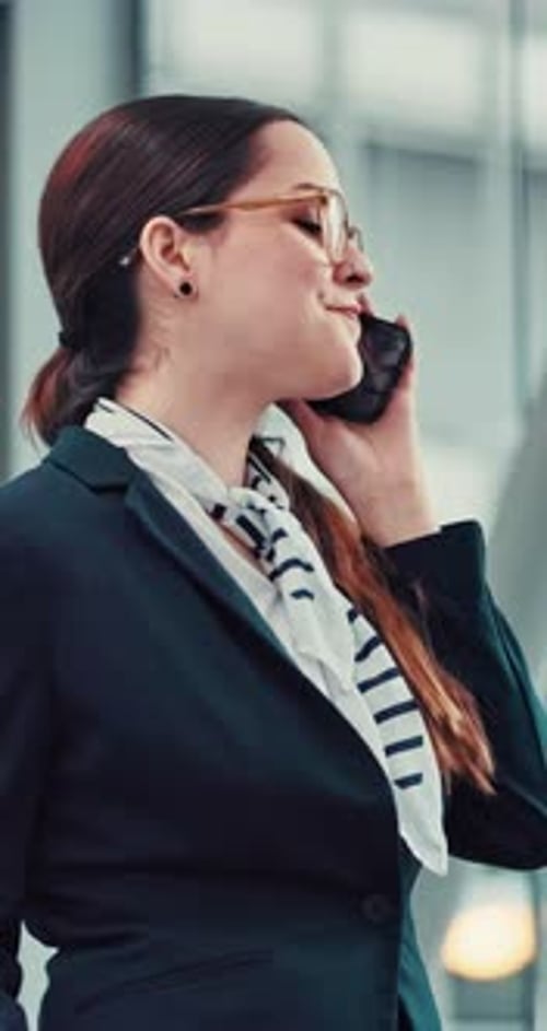 Businesswoman Speaks on Cell Phone in Office