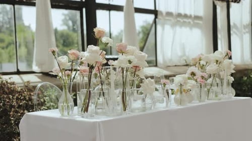 Elegant Wedding Flowers in Vases on Table