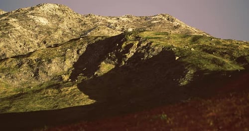 Mountain Landscape Showcasing Dramatic Shadows Under Soft Sunlight