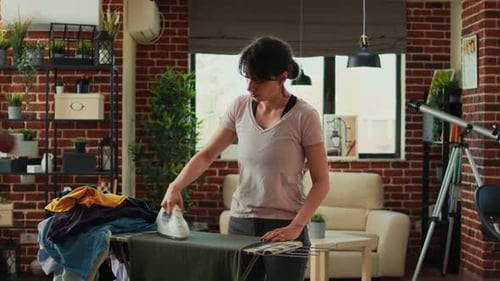 Woman Ironing Clothes in her Apartment