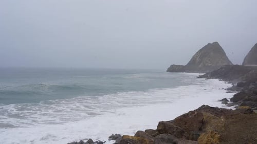 Waves crash on the shore off of Pacific Coast Highway in Southern California.