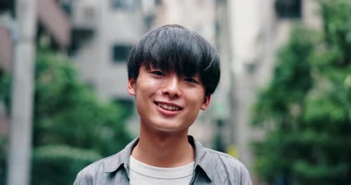 Student, happy and face of Asian man in city with smile for holiday, adventure and weekend outdoors