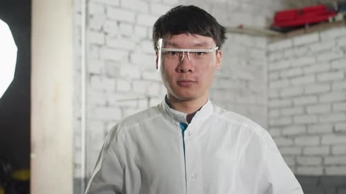 Young Adult Wearing Face Shield and Lab Coat