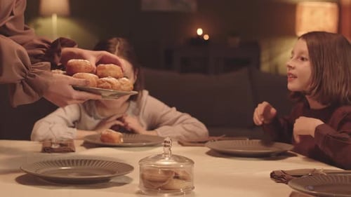 Hanukkah Family: Donuts with Children at Table