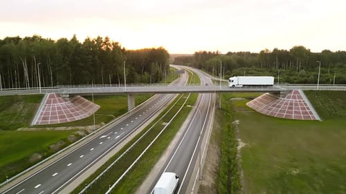 An Aerial View Captures a Highway Overpass with a Truck Passing By Against the Backdrop of a