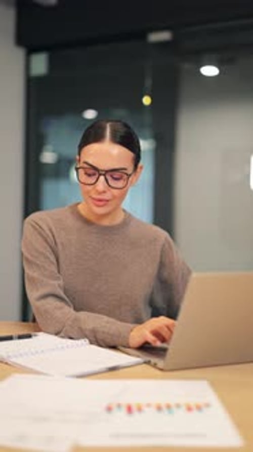 Woman Working on Laptop in Modern Office