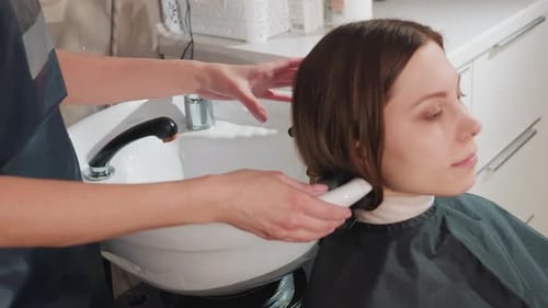 Woman Getting Hair Washed at Salon Sink
