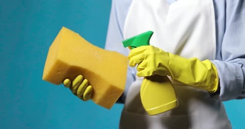 Person Holding Cleaning Supplies in Close Up