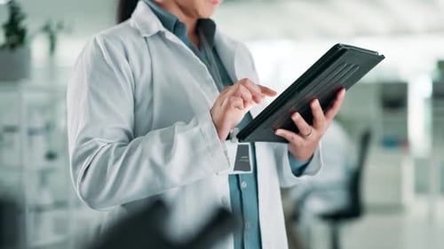 Scientist Using Tablet in Brightly Lit Lab