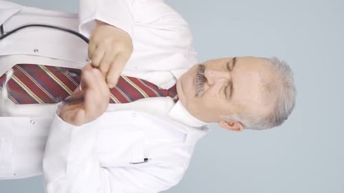 Doctor Putting on His Lab Coat and Stethoscope