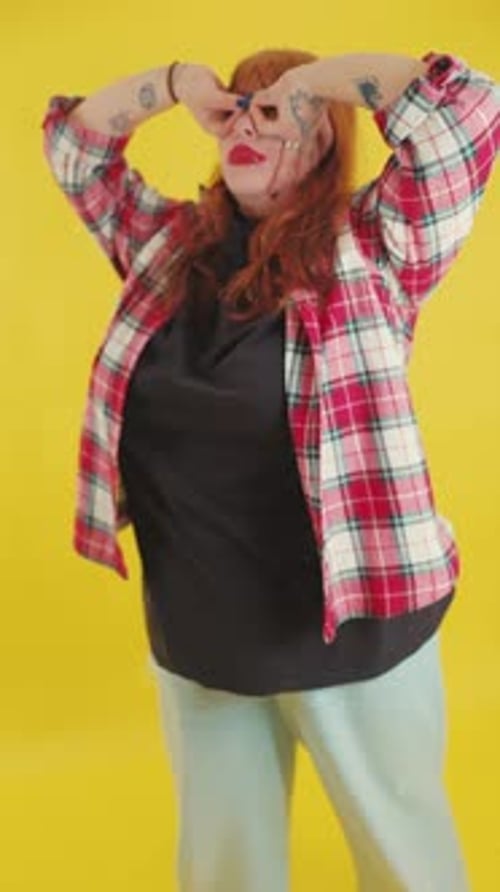 Stylish Woman Posing on a Yellow Background