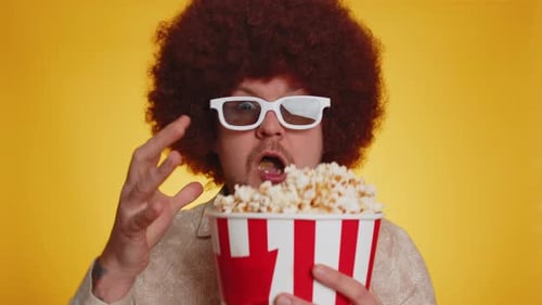 Man Wearing 3D Glasses Eats Popcorn