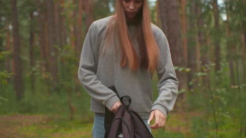 Young Hikers Walking Through Tranquil Forest Preparing for Outdoor Break
