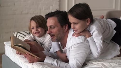 Father Reading Bedtime Story to Children