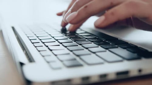 Woman's Hands Type Quickly on Laptop Keyboard