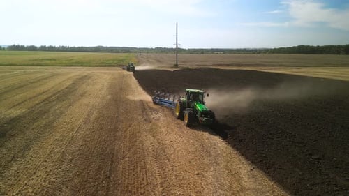 Tractors plowing the field in Ukraine