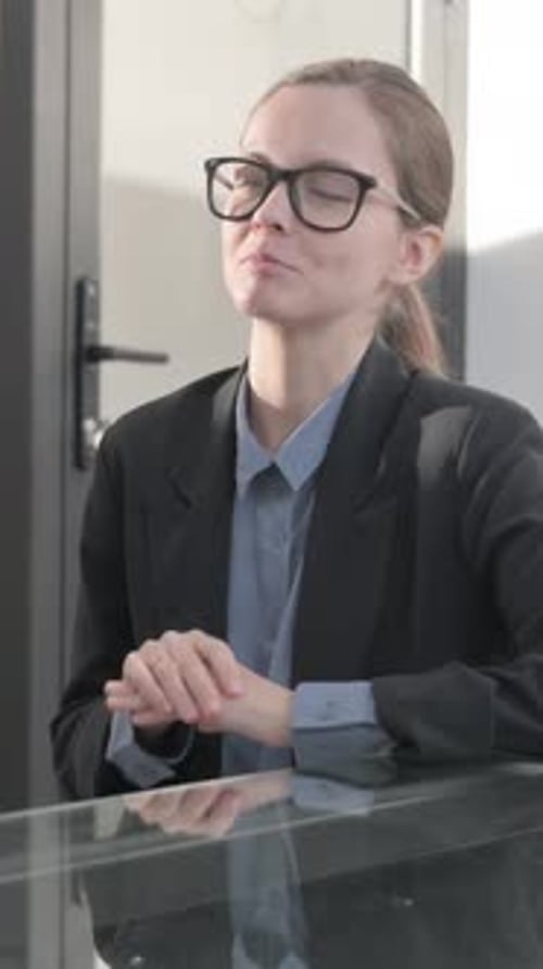 Woman in Business Attire Speaking at Reception Desk