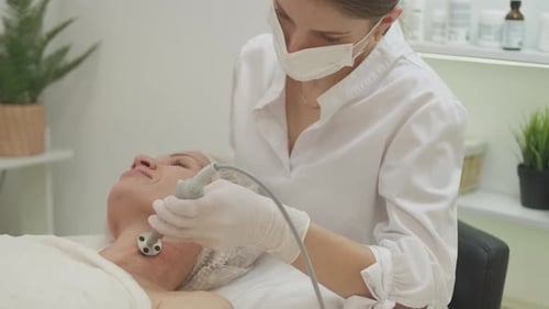 Cosmetologist Performs Facial Treatment at Spa