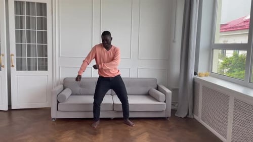 Young Man Dancing Barefoot in Living Room