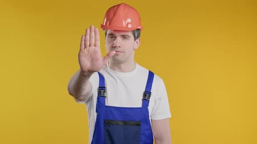 Serious Handyman Showing Rejecting Gesture By Stop Palm Not Allow Prohibition