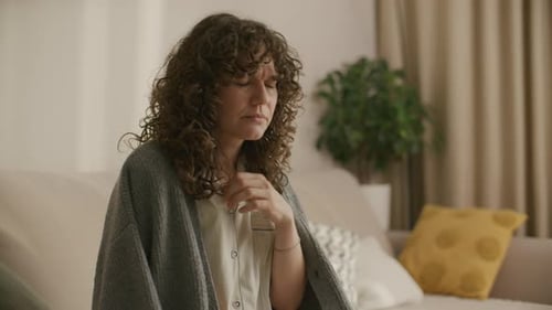 Woman Sick with Flu Checking Temperature at Home