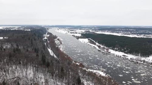 Aerial View of Snowy River Landscape in Wintertime