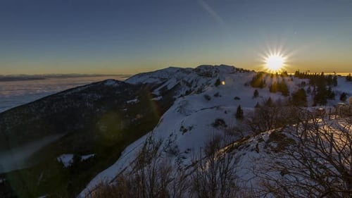 Beautiful golden hour sunset timelapse in winter with snowy mountains