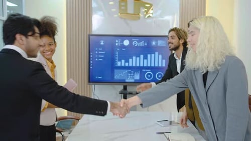 Cheerful business partners or client making deal walk in over and shake hands greeting each other