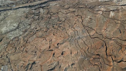 Aerial tilt-down shot of salt lake with rocky coastline drone flying forward over famous scenic Dead