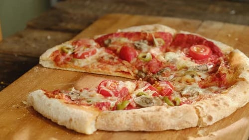 Hand Taking Slices of Baked Homemade Pizza