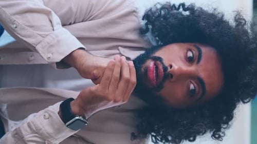 Young Tired Worried Arabian Man Feels Excited Sits on Couch in Apartment