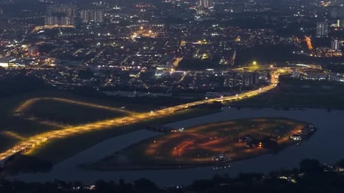 Johor city at night with a river running through it