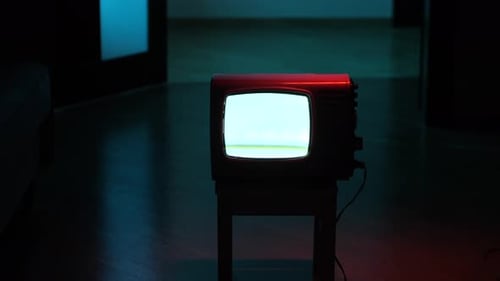 Vintage Television Displaying Static in Dark Room