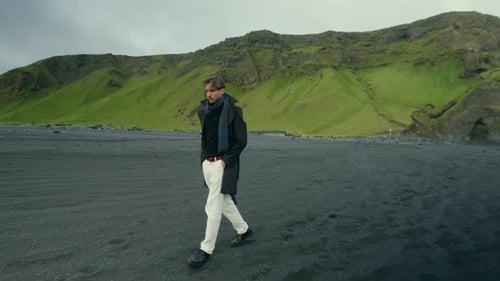 A Young Man Standing at Reynisfjara the Renowned Black Sand Beach Located in Iceland