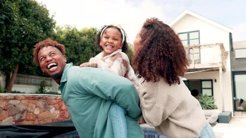 Happy Family Laughing Together in Backyard