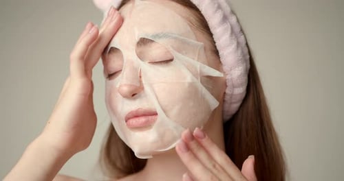Woman Applies Sheet Mask for Beauty Treatment