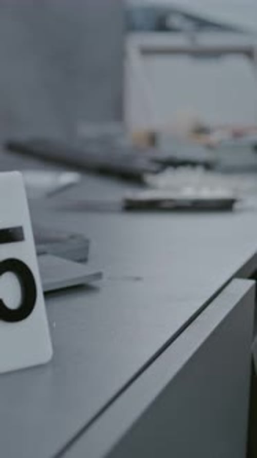 Forensic Investigator Examining Knife Blade with Brush
