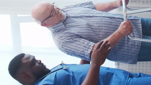 AfricanAmerican Caregiver and Old Man Professional Nurse and Patient in a Nursing Home Assistance