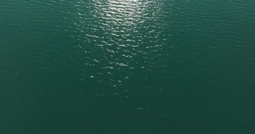 A Top View Dolly Drone Shot Looking Down At Water Of Emerald Lake